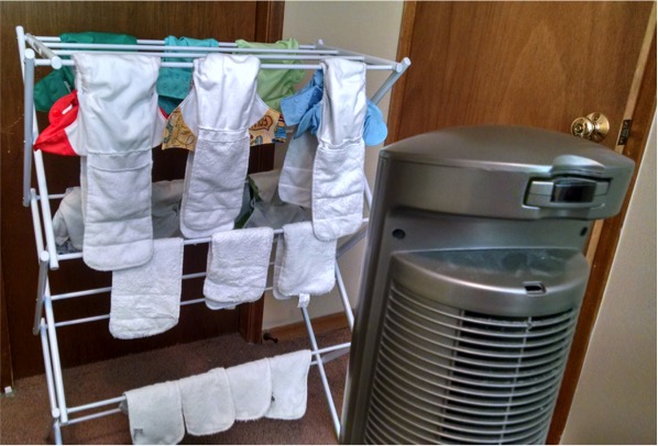 Our drying rack and fan with cloth diapers. Inserts in front, covers in back.